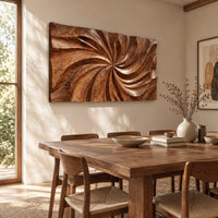 Landscape wood wall art panel with a carved swirl relief beside a dining table in natural light