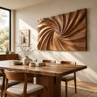 Wall art panel with a swirling carved ridge pattern radiating from the center beside a dining table in natural light