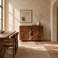Two door sideboard with a carved tree branch relief across the fronts in a bright open plan dining room