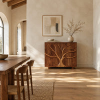 Two door sideboard with a carved tree branch relief in a bright open plan dining room