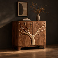 Two door sideboard with a tree carved in relief across both doors, three-quarter view showing the grain