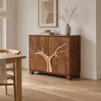 Two door sideboard with a tree carved in relief across both doors in a Scandinavian dining room with white walls