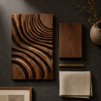 Detail of carved wooden wall panel with sweeping layered grooves beside wood, brass and linen samples