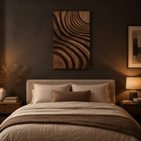 Carved wooden wall panel with sweeping layered grooves above a bed in a dusk lit bedroom