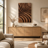 Carved wooden wall panel with sweeping layered grooves above a light oak sideboard in daylight