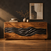 Four door sideboard with a dark carved wave band across the front in a dark studio against a charcoal plaster wall