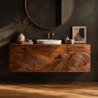 Floating bathroom vanity cabinet with three carved wave front panels in a dark studio against a charcoal plaster wall