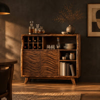Bar cabinet with carved wave doors, a wine slot grid and open shelves in a dark dining room at golden hour