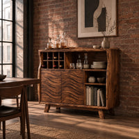 Bar cabinet with carved wave doors, a wine slot grid and open shelves in an industrial loft dining room with exposed brick