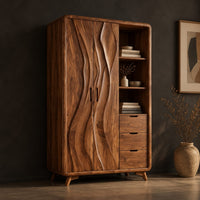 Wardrobe with carved wave pattern doors beside open shelves and three drawers, three-quarter view showing the grain