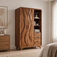 Wardrobe with carved wave pattern doors beside open shelves and three drawers in a Scandinavian bedroom with white walls