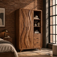Wardrobe with carved wave pattern doors beside open shelves and three drawers in an industrial loft bedroom with exposed brick