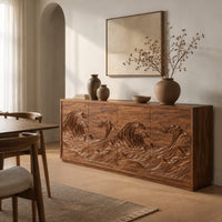 Sideboard with four doors carved in a rolling ocean wave relief in a Scandinavian dining room with white walls