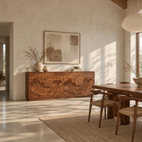 Sideboard with four doors carved in a rolling ocean wave relief in a bright open plan dining room
