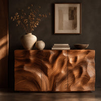 Corner detail of sideboard with three flush doors and a rolling carved wave relief front beside wood, brass and linen samples