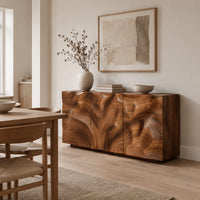 Sideboard with three flush doors and a rolling carved wave relief front in a Scandinavian dining room with white walls
