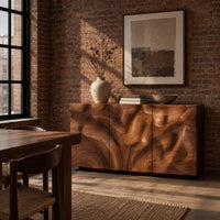 Sideboard with three flush doors and a rolling carved wave relief front in an industrial loft dining room with exposed brick