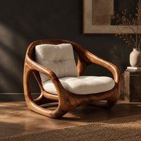 Chair with a sculpted open loop wood frame and tufted cream cushions, three-quarter view showing the grain