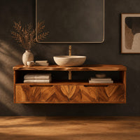 Floating cabinet with open shelf above four chevron grain fronts in a dark studio against a charcoal plaster wall