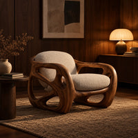 Chair with a chunky sculpted frame, large oval cutouts and a pillow back in an evening living room with walnut wall paneling