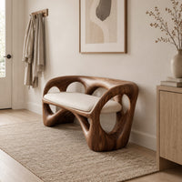 Bench with a looped wooden frame, cutout back and cream cushion in a Scandinavian entryway with white walls