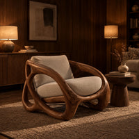 Chunky looped wood frame chair with oval openings and a cream seat in an evening living room with walnut wall paneling