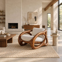 Chunky looped wood frame chair with oval openings and a cream seat in a bright open plan living room