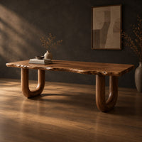 Desk with a live edge slab top and two thick sculpted legs, three-quarter view showing the grain