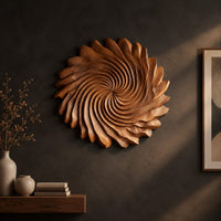 Circular wall art with spiral petal carving and a ruffled edge on a dark charcoal plaster wall