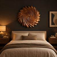 Circular wall art with spiral petal carving and a ruffled edge above a bed in a dusk lit bedroom