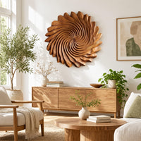 Circular wall art with spiral petal carving and a ruffled edge in a bright sunroom with green plants