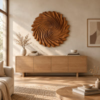 Circular wall art with spiral petal carving and a ruffled edge above a light oak sideboard in daylight