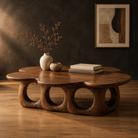 Cloud shaped coffee table on a base of round arches in a dark studio against a charcoal plaster wall