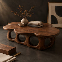 Corner detail of cloud shaped coffee table on a base of round arches beside wood, brass and linen samples