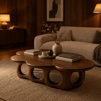Cloud shaped coffee table on a base of round arches in an evening living room with walnut wall paneling