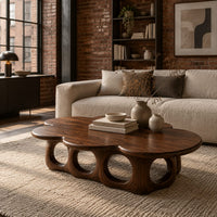 Cloud shaped coffee table on a base of round arches in an industrial loft living room with exposed brick