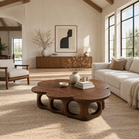 Cloud shaped coffee table on a base of round arches in a bright open plan living room