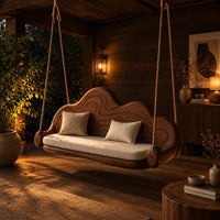 Cloud shaped swing with a carved wavy backrest and cream seat cushion in an evening porch with walnut wall paneling