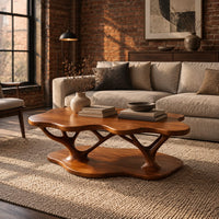 Coffee table with a cloud shaped top and branching legs in an industrial loft living room with exposed brick