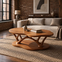 Cloud shaped coffee table with forked branch legs over a matching shaped base in an industrial loft living room with exposed brick