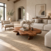 Cloud shaped coffee table with a thick wavy top and angled legs in a bright open plan living room