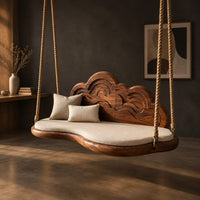 Cloud shaped swing with a carved wave backrest and a cushioned seat, three-quarter view showing the grain