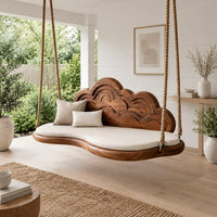 Cloud shaped swing with a carved wave backrest and a cushioned seat in a Scandinavian porch with white walls