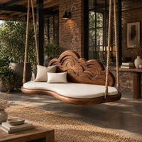Cloud shaped swing with a carved wave backrest and a cushioned seat in an industrial loft porch with exposed brick