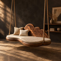 Cloud shaped swing with a scalloped carved back and a padded seat, three-quarter view showing the grain