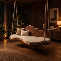 Cloud shaped swing with a scalloped carved back and a padded seat in an evening porch with walnut wall paneling
