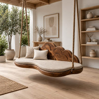 Cloud shaped swing with a scalloped carved back and a padded seat in a Scandinavian porch with white walls