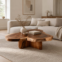 Clover shaped coffee table with three joined slabs on a three fin base in a Scandinavian living room with white walls