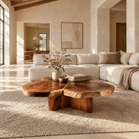 Clover shaped coffee table with three joined slabs on a three fin base in a bright open plan living room