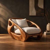 Chunky wooden chair with swirling grain and oval cutouts in the sides in a dark studio against a charcoal plaster wall